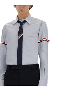 Thom Browne men’s classic light gray long-sleeved dress shirt with red white and black striped cuffs and collar
