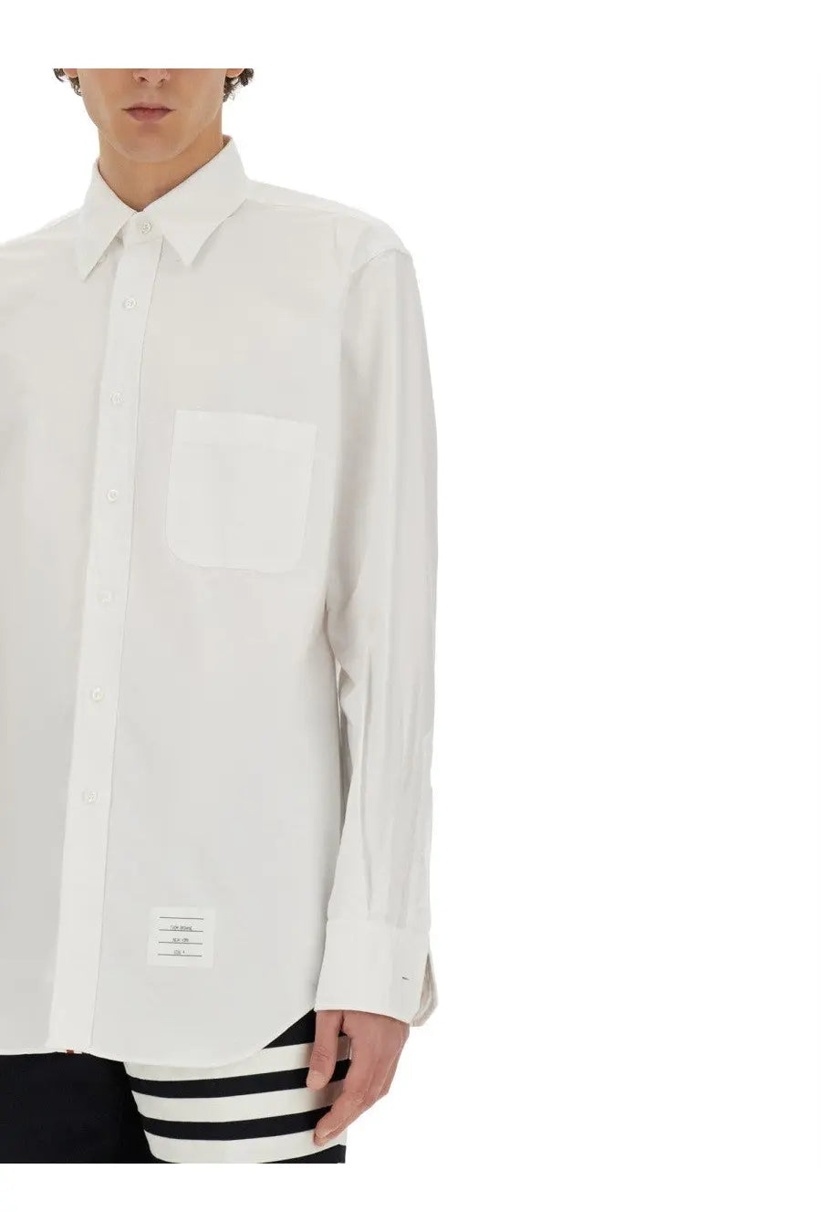 Thom Browne men’s white cotton long-sleeved button-down shirt with chest pocket and small hem label