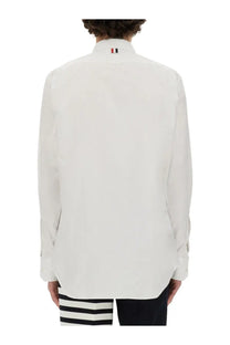 Back view of thom browne men’s white cotton dress shirt with classic collar and subtle red white blue tricolor logo