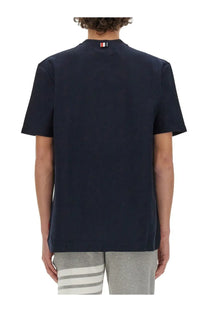 Navy blue cotton thom browne men’s jersey shirt with small striped logo at the neckline