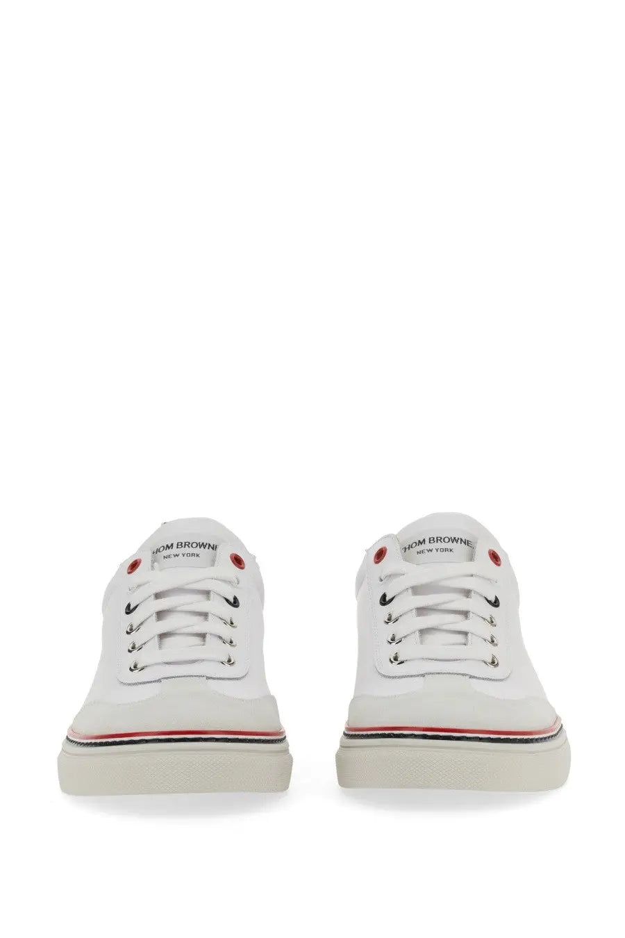 Thom browne men’s low top leather sneakers in white canvas with red and black accents and new york logo on the tongue
