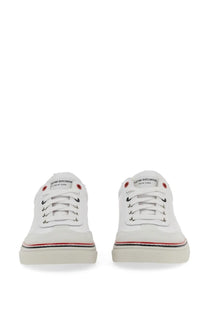 Thom browne men’s low top leather sneakers in white canvas with red and black accents and new york logo on the tongue