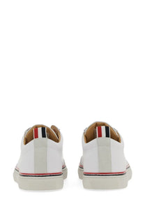 Thom Browne men’s low top white leather sneakers with classic design and red white black striped heel tab back view