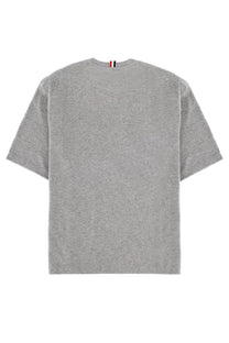 Thom browne men’s milan shirt grey is a gray heathered cotton t-shirt with a crew neck and striped tag at neckline
