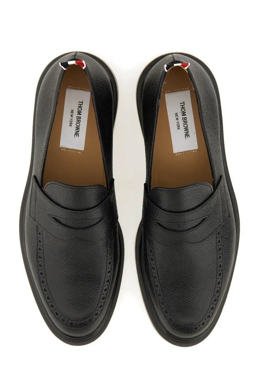 Thom Browne men’s black leather loafers with textured surface and classic brogue detailing