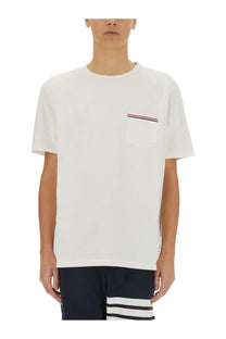 Thom Browne men’s white cotton t-shirt with a chest pocket accented by thin red white and blue stripes