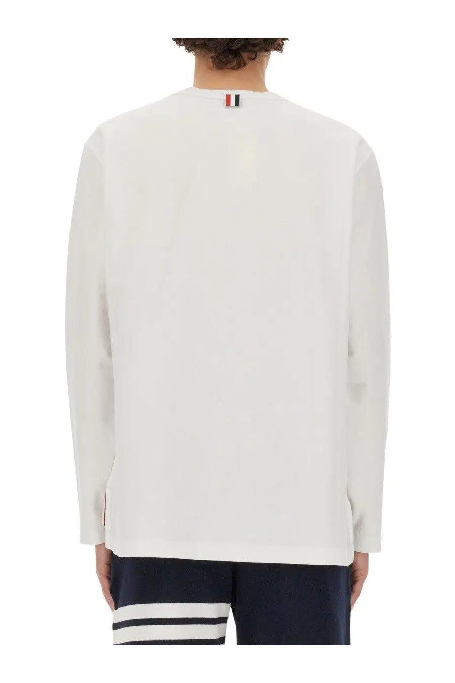 White long-sleeved thom browne men’s shirt with ribbed collar detail and logo at the back neckline shown from the back