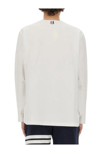 White long-sleeved thom browne men’s shirt with ribbed collar detail and logo at the back neckline shown from the back