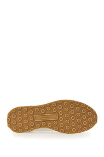 Tan rubber sole with circular tread pattern and thom browne new york label on thom browne men’s sneaker tech runner blue