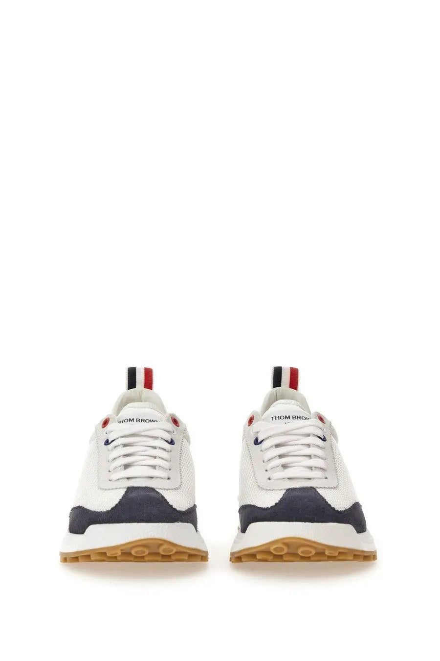 Thom Browne men’s sneaker tech runner in white and navy blue with red white black laces and gum rubber sole