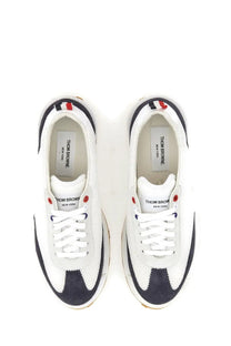 Thom Browne men’s sneaker tech runner blue in white and navy with red eyelets and textured mesh upper