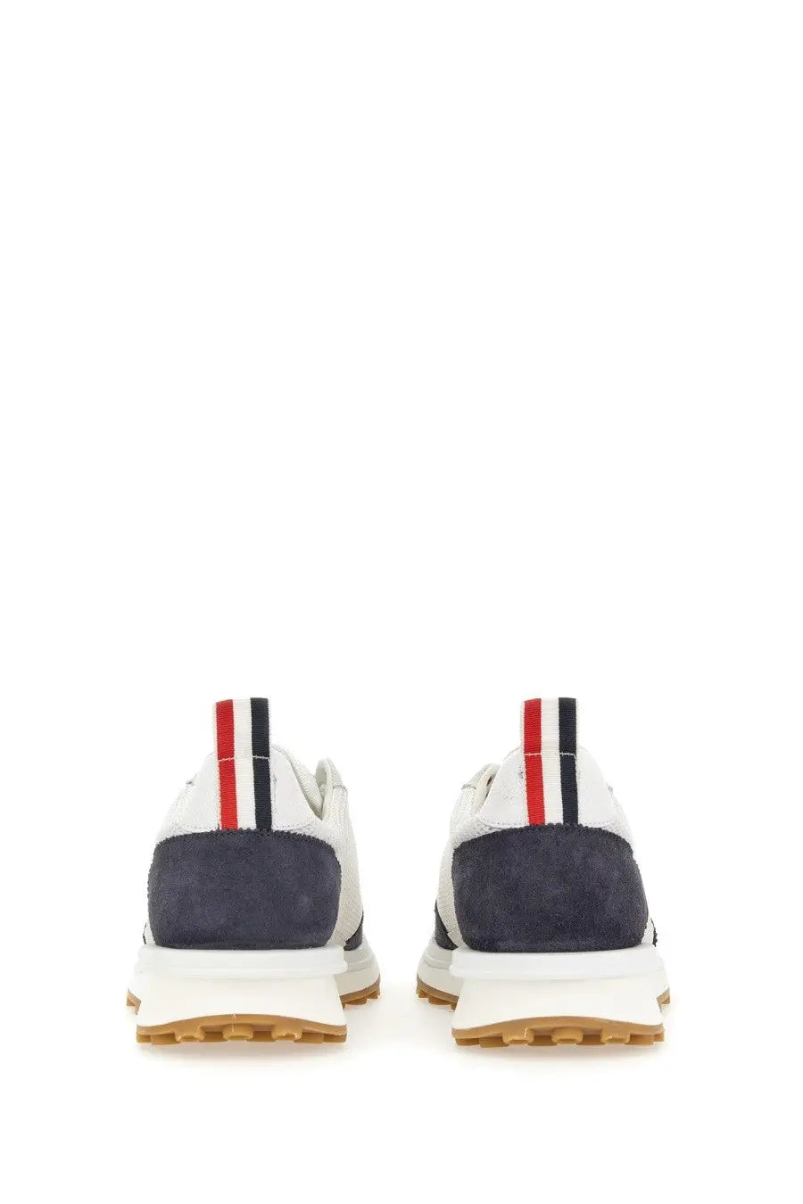 Thom browne men’s sneaker tech runner blue showing white and navy suede sneakers with striped heel tabs back view