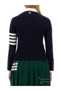Thom Browne women’s navy blue knit sweater with white sleeve stripes and red white blue logo at neckline