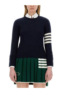 Thom Browne women’s navy blue knit sweater with white striped sleeves hem and classic collar with buttoned cuffs