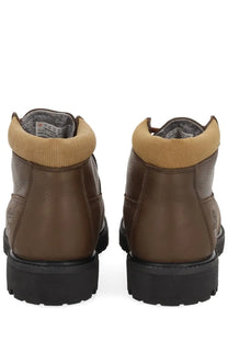 Timberland men’s waterproof brown leather chukka boot with tan ribbed collar and black rubber soles
