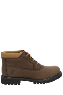 Timberland men’s waterproof chukka boot in brown leather with tan laces and black rubber sole for outdoor use