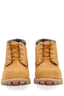 Timberland men’s waterproof chukka boot in tan leather with yellow laces and rugged rubber sole for durability