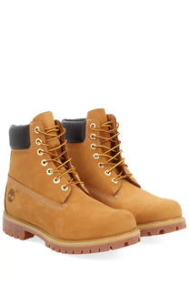 Timberland men’s waterproof tan 6-inch lace-up boots with black collar and gold laces for outdoor use