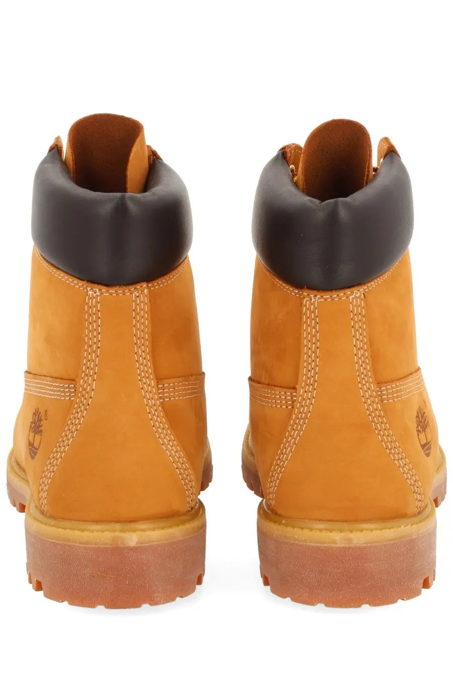 Tan timberland men’s waterproof 6-inch lace up boots with black rubber collar and contrasting stitching