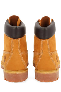 Tan timberland men’s waterproof 6-inch lace up boots with black rubber collar and contrasting stitching