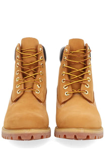 Timberland men’s waterproof tan leather 6-inch boots with gold laces and metallic eyelets for durable outdoor wear