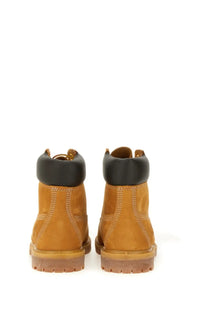 Timberland women’s waterproof tan leather 6-inch lace up boot with black rubber collar and gum sole