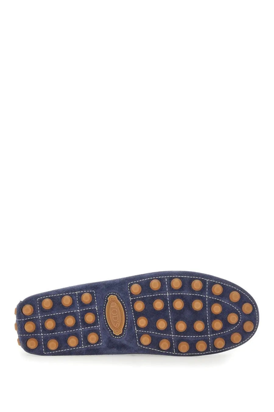 Navy blue suede sole of Tods men’s leather loafer with tan rubber dots and brown leather Tods logo patch visible