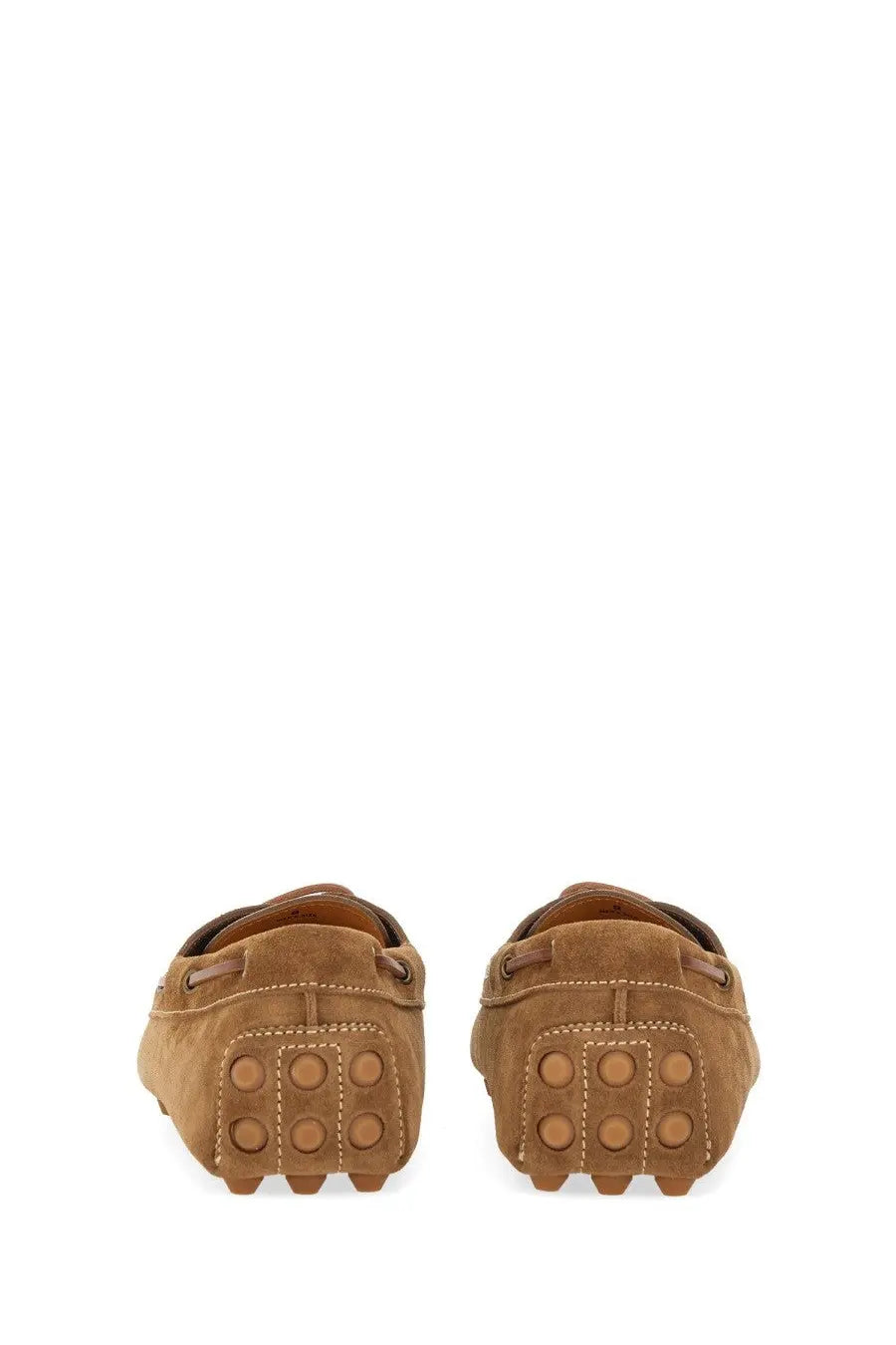 Tod’s men’s leather loafer brown in tan suede with classic moccasin design and circular tread sole pattern
