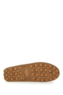 Tan suede sole of tods men’s leather loafer brown featuring circular rubber studs and stitched seams