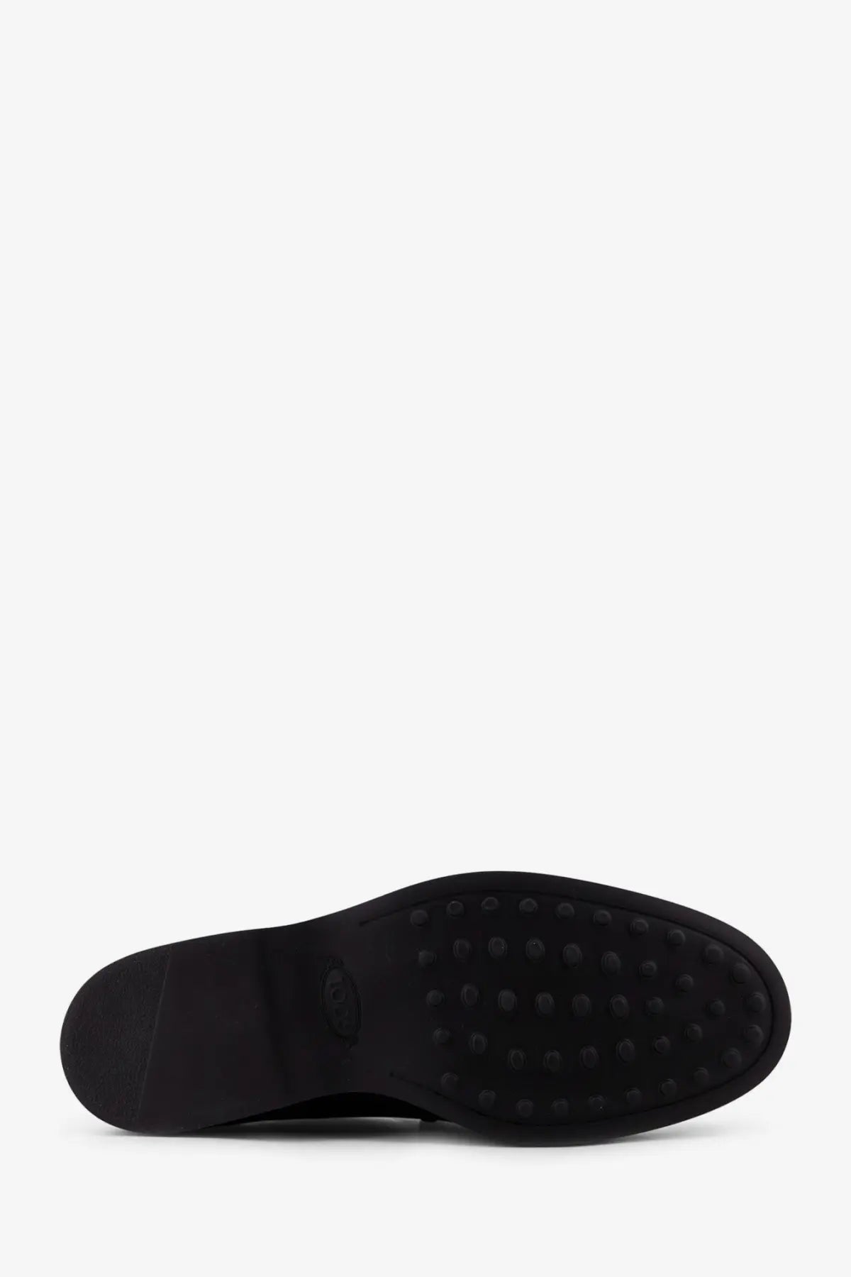 Black rubber sole with small circular studs on Tod’s men’s leather loafers black showing grip detail