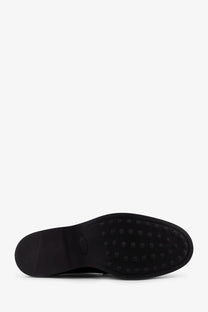 Black rubber sole with small circular studs on Tod’s men’s leather loafers black showing grip detail
