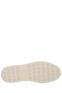 Tod’s men’s moccasin cassette beige with cream-colored rubber sole featuring circular indentations and oval logo in center