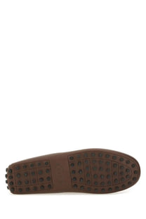 Tod’s men’s moccasin gommino bubble brown leather driving shoe with textured rubber sole and circular tread patterns