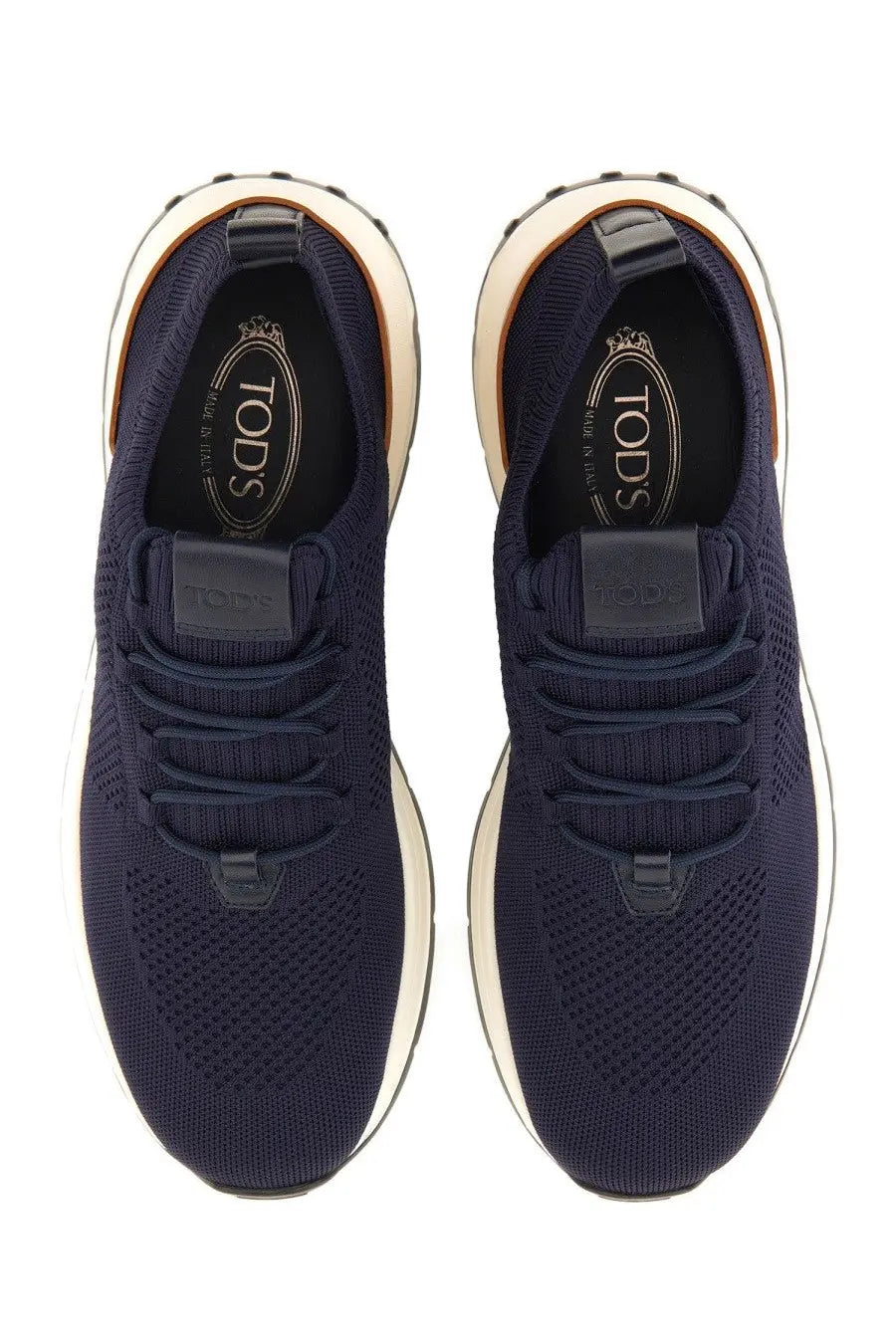 Tod’s men’s sneaker socks in navy blue knit with white rubber soles and black Tod’s branding on insole and tongue
