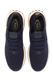 Tod’s men’s sneaker socks in navy blue knit with white rubber soles and black Tod’s branding on insole and tongue