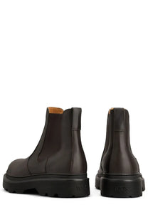 Tod’s men’s stivale chelsea brown dark brown leather boots with chunky black rubber sole showing back side and toes branding