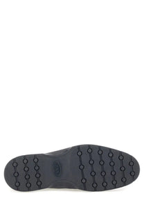 Black rubber sole with circular tread pattern and embossed tods logo on tods men’s blue suede loafer
