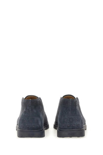 Dark blue suede chukka boots with embossed logo on the heel from Tod’s men’s suede loafer blue collection showing back view
