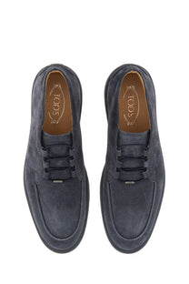 Tod’s men’s suede loafer in dark blue with black laces and a classic slip-on design