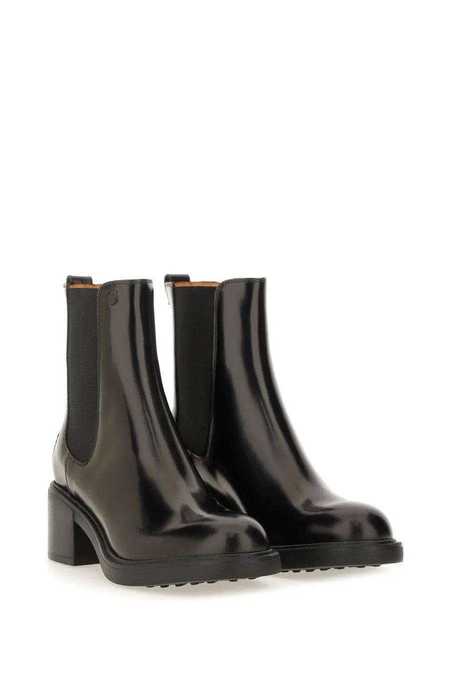Tod’s women’s black leather chelsea boots with black patent leather, chunky block heel, and textured rubber sole