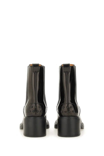 Tod’s women’s black leather chelsea boots with chunky block heel and embossed logo detail on the back side