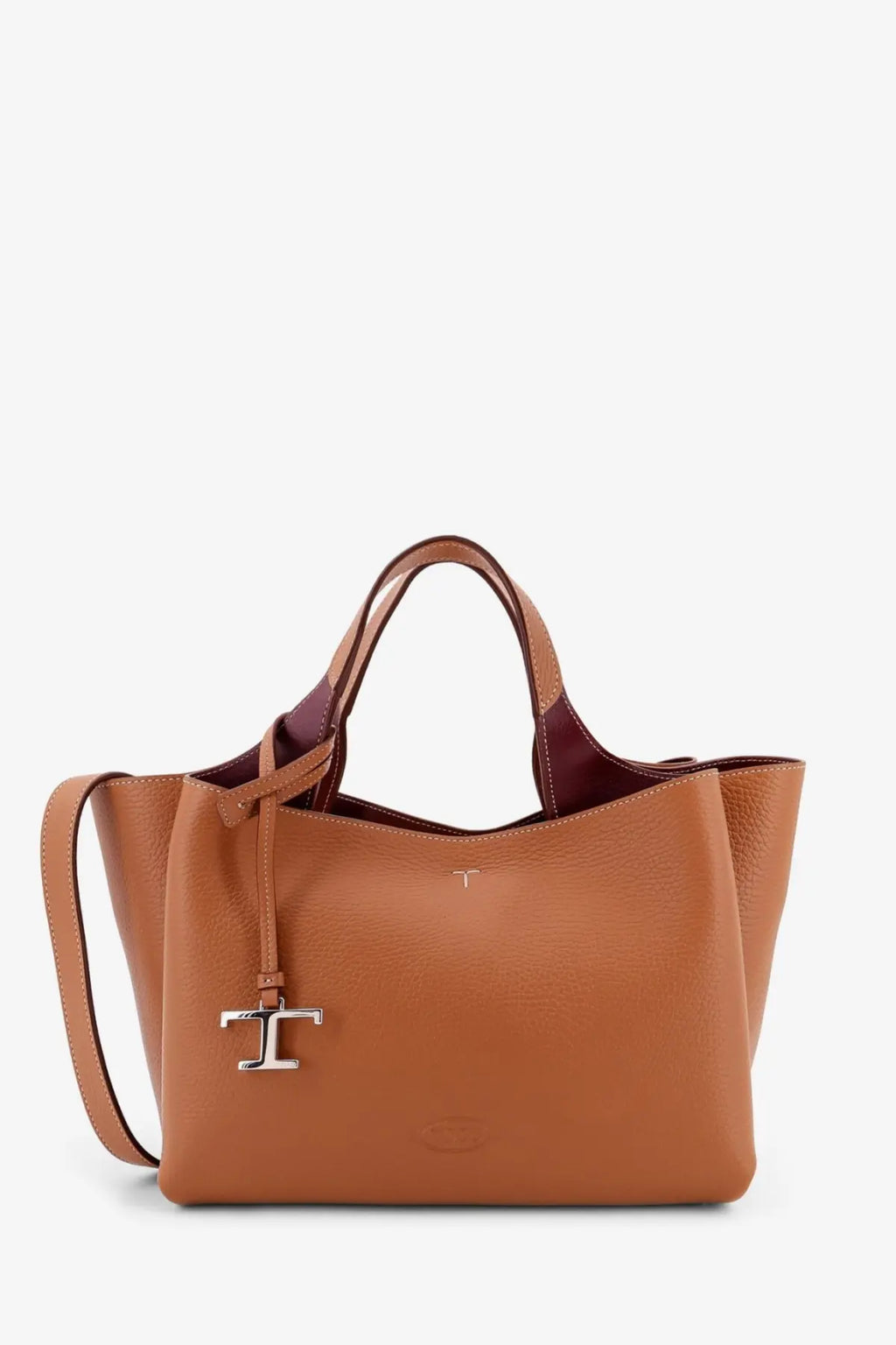 Tod’s women’s tan leather tote bag with burgundy interior and silver-tone t logo charm on the front