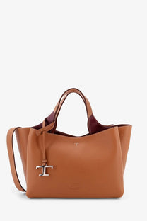 Tod’s women’s tan leather tote bag with burgundy interior and silver-tone t logo charm on the front
