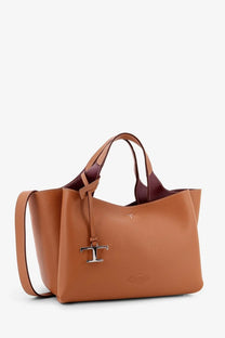 Tod’s women’s brown leather crossbody bag with tan leather tote design and burgundy interior with silver t logo charm