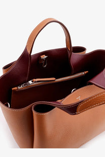 Tod’s women’s leather crossbody bag brown with two-toned tan exterior and rich burgundy interior tote design