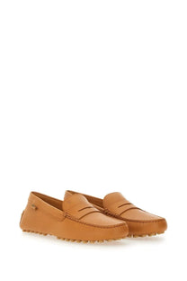 Tod’s women’s leather gommino loafer beige with tan leather, classic moccasin design, and textured rubber soles
