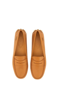 Tan leather Tods women’s gommino loafer with classic moccasin design and stitched detailing in beige