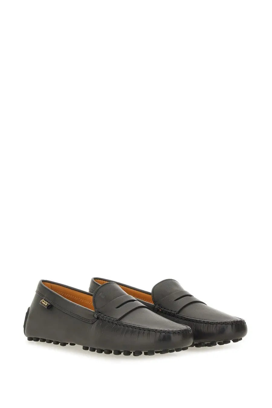 Tod’s women’s leather gommino loafer in black features classic moccasin design and contrasting tan leather lining
