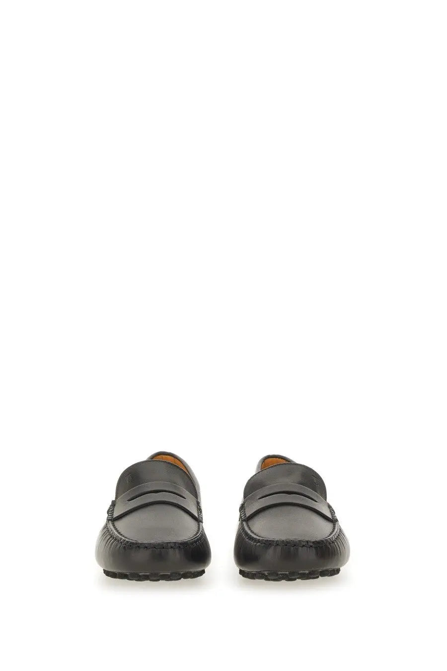 Tods women’s leather gommino loafer in black with classic penny loafer design and contrasting tan lining