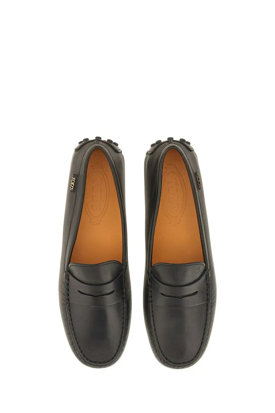 Tod’s women’s leather gommino loafer in black with classic moccasin design and tan lining